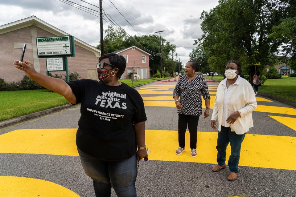 People come out to see "Black Towns Matter" which is painted on a street on June 19, 2020 in Houston, Texas.