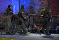 Heavily armed police officers exit the Corona Costco following a shooting inside the wholesale warehouse in Corona, Calif., Friday, June 14, 2019. A gunman opened fire inside the store during an argument, killing a man, wounding two other people and sparking a stampede of terrified shoppers before he was taken into custody, police said. The man involved in the argument was killed and two other people were wounded, Corona police Lt. Jeff Edwards said. (Will Lester/Inland Valley Daily Bulletin/SCNG via AP)