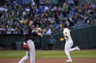Oakland Athletics' Brent Rooker, right, runs the bases after hitting a two-run home run against Miami Marlins pitcher Ryan Weathers, foreground, during the fourth inning of a baseball game Friday, May 3, 2024, in Oakland, Calif. (AP Photo/Godofredo A. Vásquez)