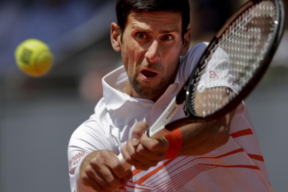 Novak Djokovic, from Serbia, returns the ball to Taylor Fritz, from United States during the Madrid Open tennis tournament in Madrid, Tuesday, May 7, 2019. (AP Photo/Bernat Armangue)