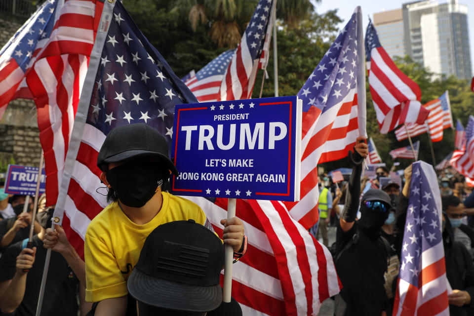 FILE - In this Dec. 1, 2019, file photo, protesters stage a rally outside the U.S. Consulate in Hong Kong. From Tokyo to Brussels, political leaders have swiftly decried Beijing's move to impose a tough national security law on Hong Kong that cracks down on subversive activity and protest in the semi-autonomous territory. But the rhetoric from democratic nations has more bark than bite. (AP Photo/Vincent Thian, File)