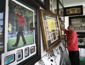 FILE - In this April 8, 2010, file photo, vendor Roger E. Gilchrist hangs memorabilia for sale in his tent outside the gates of the Augusta National Golf Club, the site of the Masters golf tournament in Augusta, Ga. The Masters is so intertwined with Augusta, they added an extra day to spring break. You see, the first full week of April isn't just a blip in time for this place. It's their identity, their way of life, their golf-cart path to success. (AP Photo/Rob Carr, File)