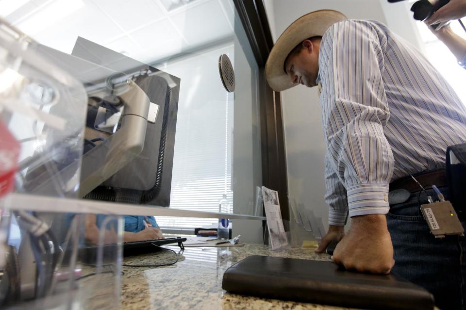 Ammon Bundy, son of rancher Cliven Bundy files a criminal complaint against the Bureau of Land Management at Metropolitan Police Department headquarters, Friday, May 2, 2014 in Las Vegas. Last month, federal agents launched a cattle roundup on the Bundy ranch after they refused a court order to remove their cattle from public land and pay a grazing fee.(AP Photo/Chris Carlson)