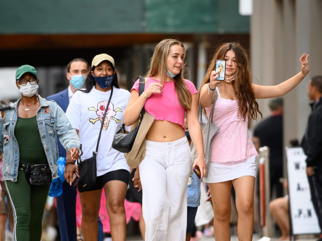 Two teenagers take a selfie while walking in SoHo