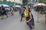 Anti-coup protesters run after seeing police and soldiers arrive to disperse their demonstration in Yangon, Myanmar, Tuesday, April 27, 2021. Demonstrations have continued in many parts of the country since Saturday's meeting of leaders from the Association of Southeast Asian Nations, as have arrests and beatings by security forces despite an apparent agreement by junta leader Senior Gen. Min Aung Hlaing to end the violence. (AP Photo)