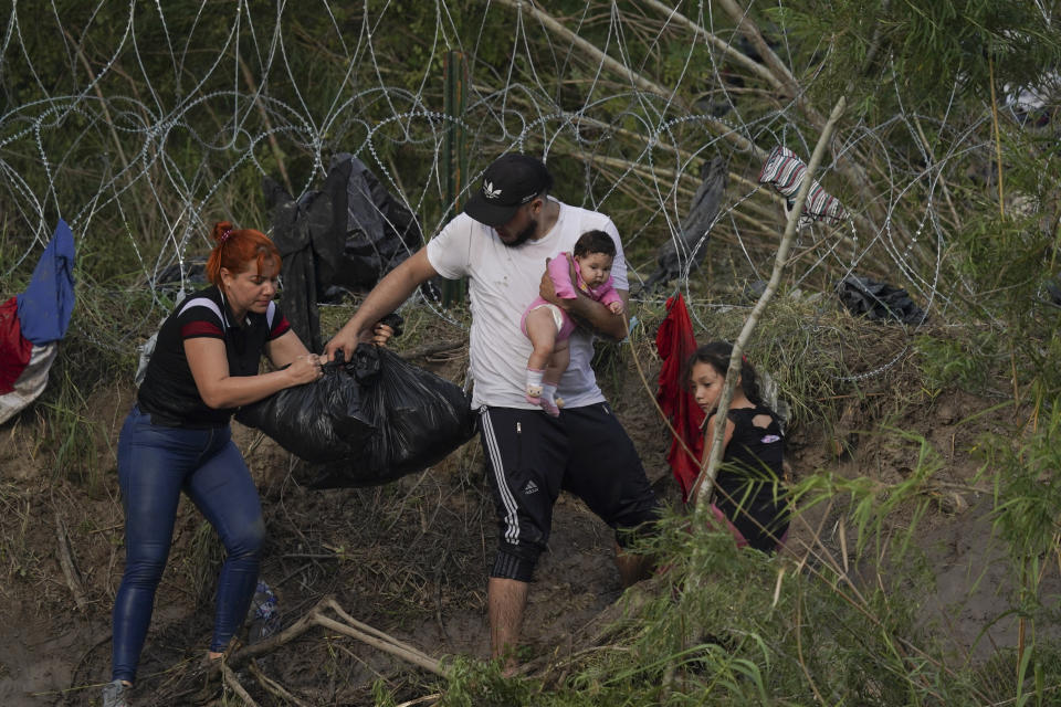 Migrants walk up the bank on the U.S. side of the Rio Grande river, as seen from Matamoros, Mexico, Wednesday, May 10, 2023. Asylum seekers have been showing up at the US-Mexico border in huge numbers in anticipation of the restriction of Title 42, that had allowed the government to quickly expel migrants to Mexico. New measures were announced Wednesday creating new legal pathways for migrants. (AP Photo/Fernando Llano)