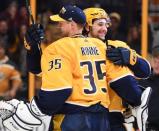 Apr 7, 2018; Nashville, TN, USA; Nashville Predators left wing Filip Forsberg (9) and goalie Pekka Rinne (35) celebrate after a win against the Columbus Blue Jackets at Bridgestone Arena. Mandatory Credit: Christopher Hanewinckel-USA TODAY Sports