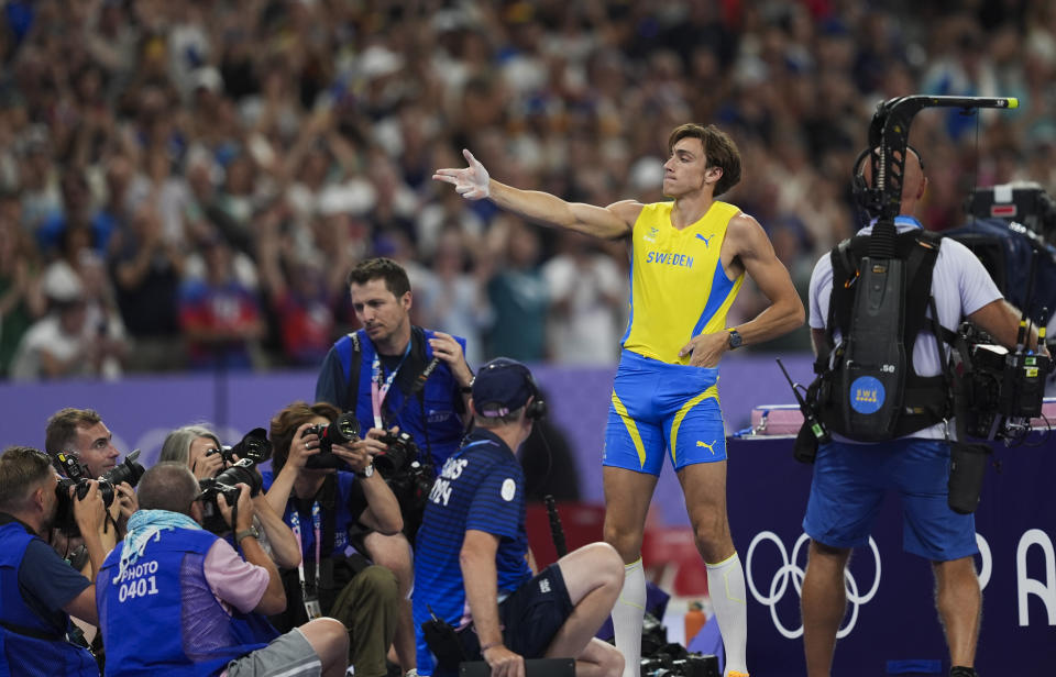 PARIS, FRANCE - AUGUST 05: Sweden's Armand Duplantis celebrates his victory with the famous shooting pose of Turkish Olympic silver medalist shooter Yusuf Dikec after passing 6.10m and setting the new Olympic record in the men's pole vault final of the athletics event at the Paris 2024 Olympic Games at Stade de France in Saint-Denis, north of Paris, on August 5, 2024. (Photo by Mustafa Ciftci/Anadolu via Getty Images)