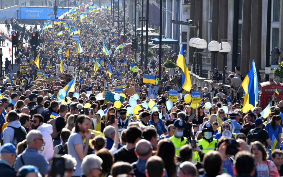 Demonstrators wave Ukrainian flags in London - Justin Tallis/AFP