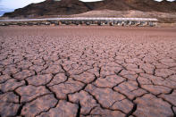 FILE - In this July 16, 2014 file photo, what was once a marina sits high and dry due to Lake Mead receding in the Lake Mead National Recreation Area in Arizona. Extreme swings in weather are expected as part of a changing climate, something Brad Udall, a water and climate research scientist at Colorado State University, has called "weather whiplash." The drought-stricken Southwest got a reprieve this year with average and above-average snowfall following a year that sent many states into extreme drought. Nearly empty reservoirs quickly rose, including Lake Mead and Lake Powell, the largest man-made reservoirs in the country that hold back Colorado River water. (AP Photo/John Locher, File)