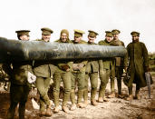 <p>A group of men from the Royal Regiment of Artillery, photographed alongside a long-barrelled field gun, 1916. For the occasion, they have chalked the words, ‘Somme gun’ on the side of the barrel. The men are well wrapped with non-uniform scarves, gloves and a balaclava. In purely military terms, the heavy artillery of both sides was in many ways more important than any other weapon. It could fire into the opposing trenches with little risk to their own side and could effectively keep the enemy in the trenches. (Tom Marshall/mediadrumworld.com) </p>