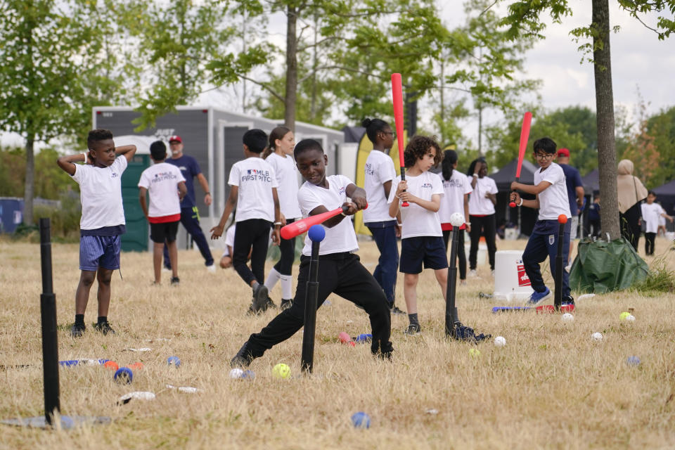 A kid hits a baseball during the MLB First Pitch Festival, at the Queen Elizabeth Olympic Park, in London, Thursday, June 22, 2023. Britain's relative success at the World Baseball Classic and the upcoming series between the Chicago Cubs and St. Louis Cardinals has increased London's interest about baseball. The sport's governing body says it has seen an uptick in interest among kids. (AP Photo/Alberto Pezzali)