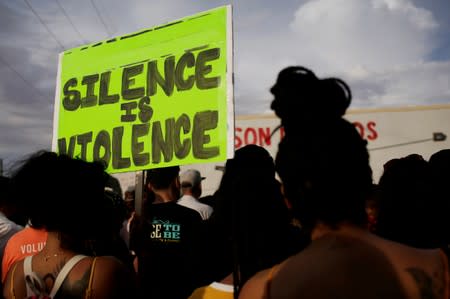 FILE PHOTO: People take part in a rally against hate a day after a mass shooting at a Walmart store, in El Paso