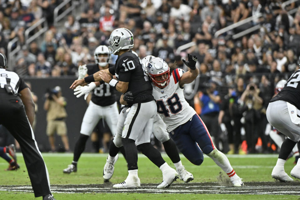 Las Vegas Raiders quarterback Jimmy Garoppolo is hit by New England Patriots linebacker Jahlani Tavai during the first half of an NFL football game Sunday, Oct. 15, 2023, in Las Vegas. (AP Photo/David Becker)