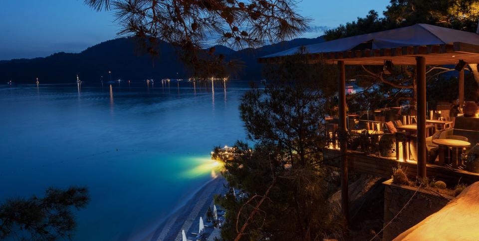 a body of water with a dock and a building by it