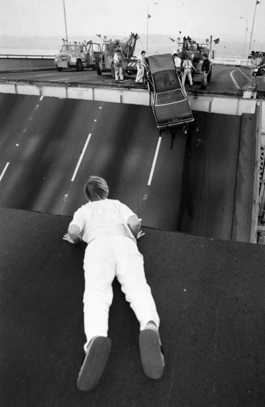 A man watches as a car, which plunged down due to collapsed San Francisco-Oakland Bay Bridge, is being hoisted up after the October 17, 1989, Loma Prieta earthquake. UPI File Photo