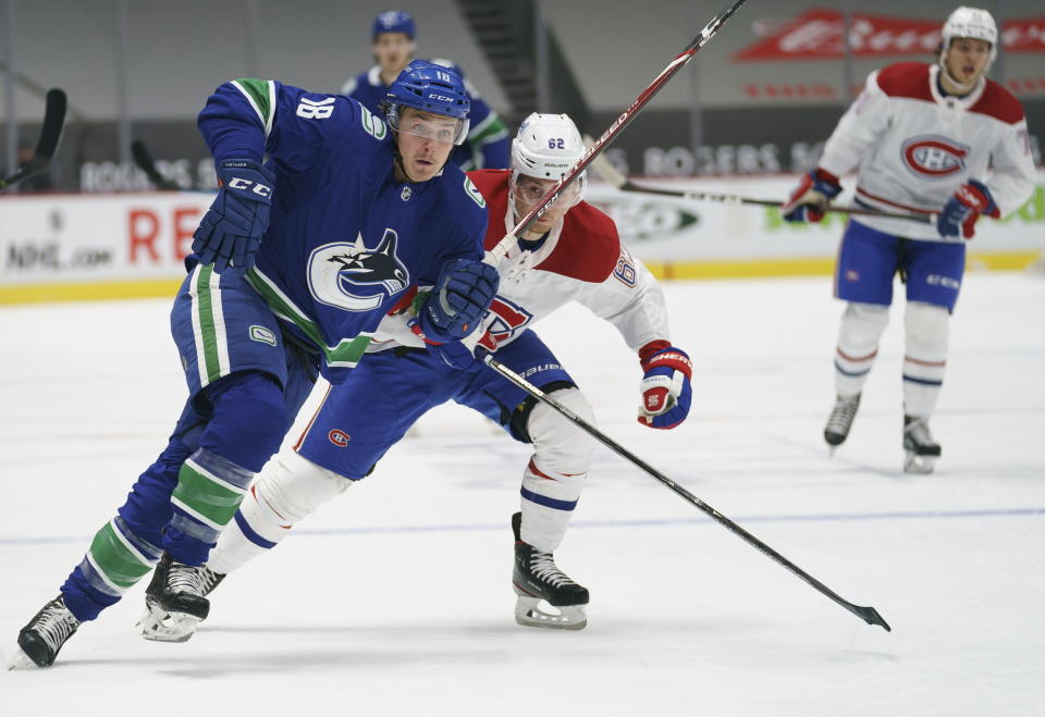 FILE - In this Jan. 21, 2021, file photo, Vancouver Canucks right wing Jake Virtanen (18) chases the puck with Montreal Canadiens left wing Artturi Lehkonen (62) during the second period of an NHL hockey game in Vancouver, British Columbia. Red Wings defenseman Marc Staal is staying put in Detroit, while the Canucks placed Virtanen on waivers on Sunday, July 25, 2021, for the purpose of buying out the final year of the under-performing forward’s contract. (Jonathan Hayward/The Canadian Press via AP, File)