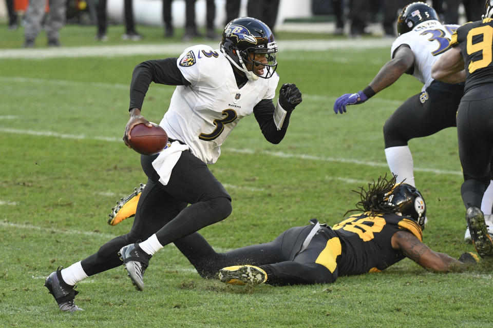 Baltimore Ravens quarterback Robert Griffin III (3) scrambles past Pittsburgh Steelers outside linebacker Bud Dupree (48) during the first half of an NFL football game, Wednesday, Dec. 2, 2020, in Pittsburgh. (AP Photo/Don Wright)