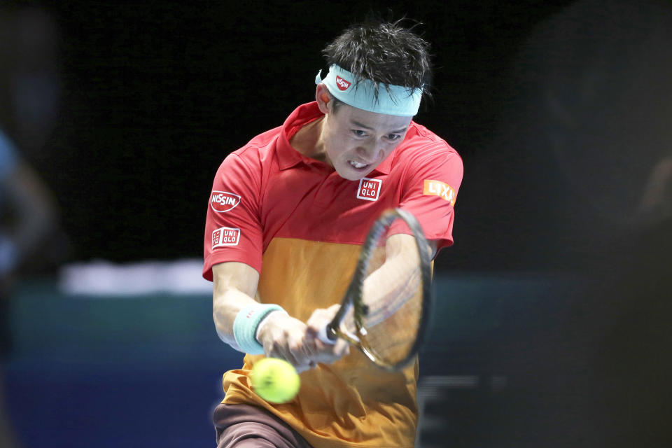 Japan's Kei Nishikori plays a return to Switzerland's Roger Federer in their ATP World Tour Finals singles final tennis match at the O2 Arena in London, Sunday Nov. 11, 2018. (AP Photo/Tim Ireland)