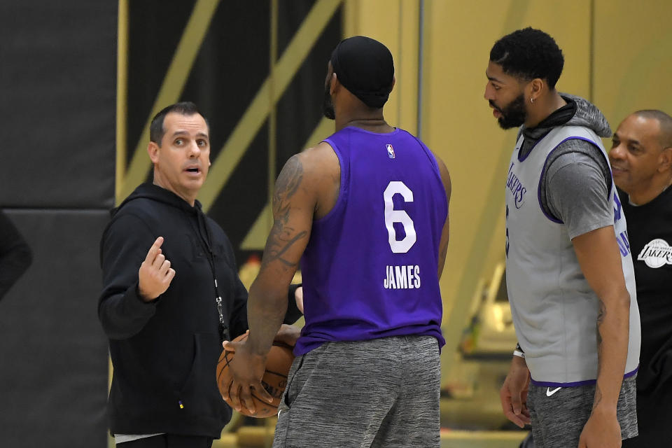 Los Angeles Lakers head coach Frank Vogel, left, talks with forward LeBron James, center, and forward Anthony Davis at their NBA basketball practice facility, Wednesday, Jan. 29, 2020, in El Segundo, Calif. The Lakers held their first practice since the team was rocked by Kobe Bryant's death in a helicopter crash. (AP Photo/Mark J. Terrill)