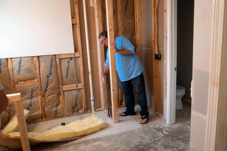 Escambia County resident David Bryan describes the lack of work completed by Banks Construction on his home's bathroom on Monday, Aug. 8, 2022. Banks Construction began the remodel late last year and has not finished the job after taking thousands of dollars in payment. 