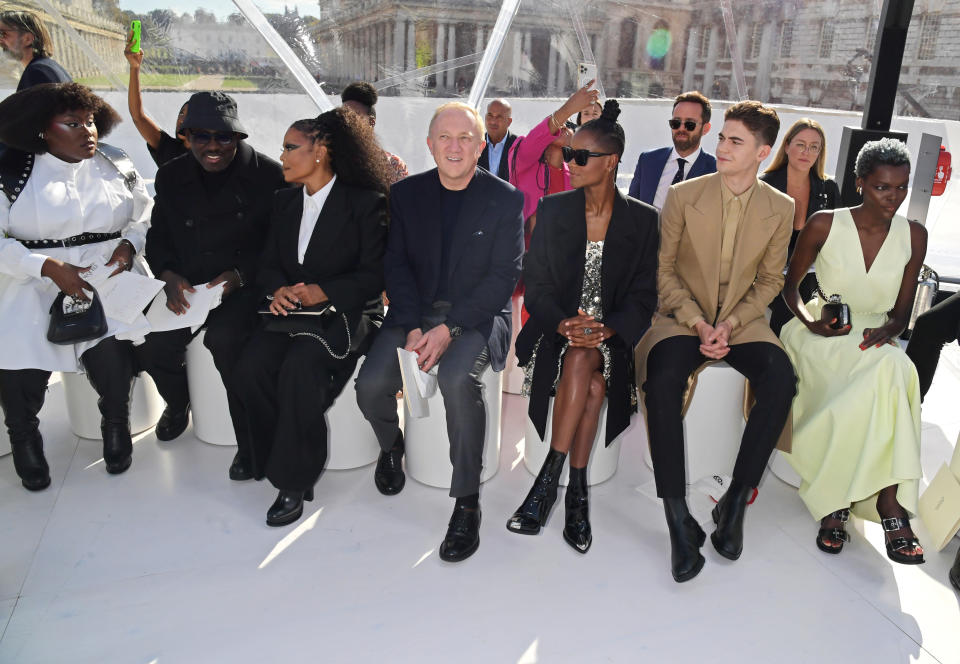 LONDON, ENGLAND - OCTOBER 10: (L to R) Yseult, Editor-In-Chief of British Vogue Edward Enninful, Janet Jackson, Francois-Henri Pinault, Letitia Wright, Hero Fiennes-Tiffin and Sheila Atim attend the Alexander McQueen SS23 Womenswear show at the Old Royal Naval College on October 11, 2022 in Greenwich, England. (Photo by David M. Benett/Dave Benett/Getty Images for Alexander McQueen)