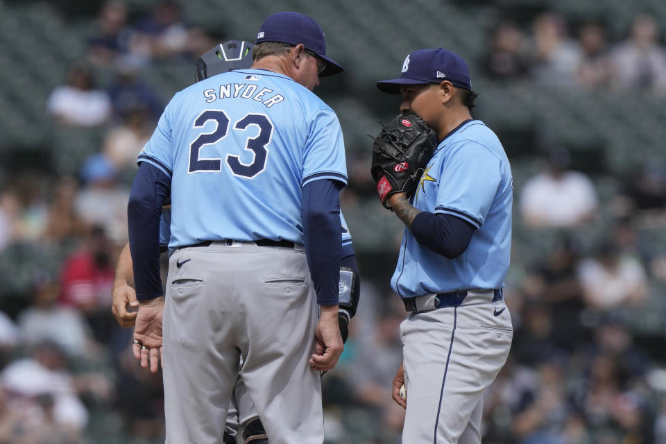 Tampa Bay Rays relief pitcher Manuel Rodríguez, right, listens to pitching coach Kyle Snyder during the eighth inning of a baseball game against the Chicago White Sox in Chicago, Sunday, April 28, 2024. (AP Photo/Nam Y. Huh)