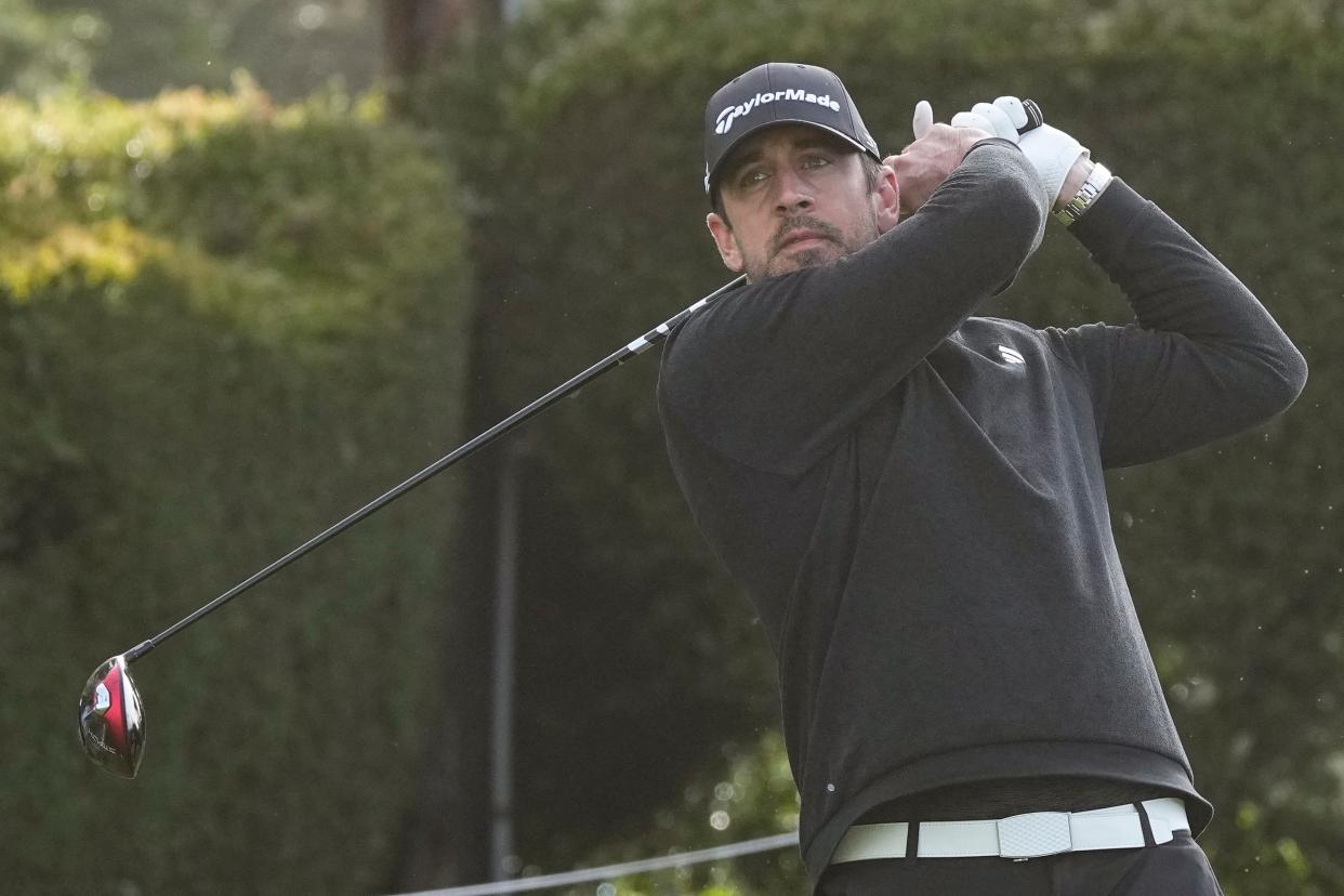 Aaron Rodgers hits his tee shot on the 15th hole during the third round of the AT&T Pebble Beach Pro-Am golf tournament Sunday. Rodgers won the event with golfer Ben Silverman.