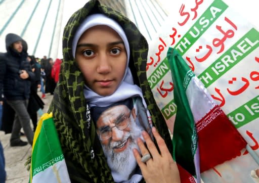 An Iranian girl holds a potrait of the country's Supreme Leader Ali Khamenei during a ceremony celebrating the 40th anniversary of the Islamic revolution in Tehran on February 11, 2019