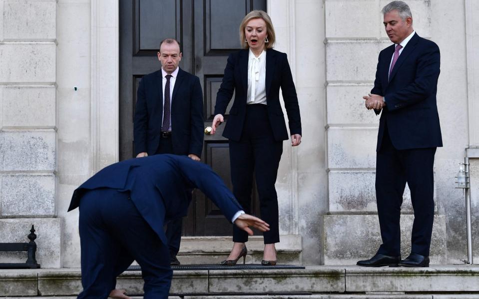 Liz Truss reacts as Maros Sefcovic stumbles on an icy step before the talks - Ben Stansall/AFP via Getty Images