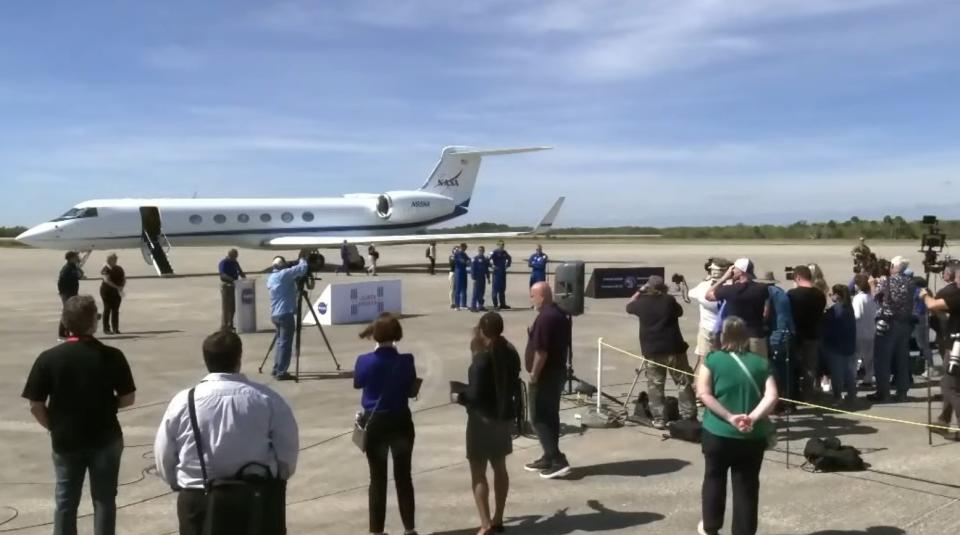 The crewmembers of the SpaceX Crew-6 mission are greeted by reporters at Kennedy Space Center on Feb. 21.