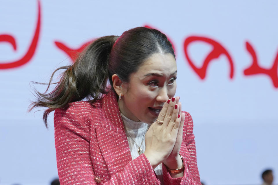 Paetongtarn Shinawatra, one of the opposition Pheu Thai Party's three registered nominees for prime minister, gives the traditional greeting or "wai" to supporters at Thammasat University's indoor gymnasium in Pathum Thani province, north of Bangkok, Thailand, on March 17, 2023. Voters disaffected by nine years of plodding rule by a coup-making army general are expected to deliver a strong mandate for change in Thailand's general election Sunday, May 14, 2023. (AP Photo/Sakchai Lalit)