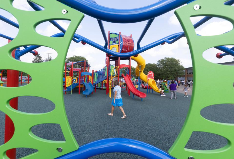 A view through some of the playground equipment at the new Southeast Community Playground in Canton.