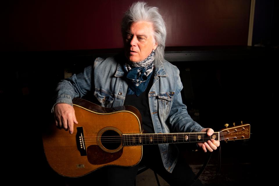 Marty Stuart holds Johnny Cash’s guitar at Marty Stuart's warehouse in Hendersonville, Tenn., Wednesday, May 18, 2022.