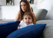 Emmanuelle Lteif Khnaisser, who was in labour at the moment of last year's Beirut port blast, sits on a sofa with her son, baby George Khnaisser, at the family home in Jal el-Dib