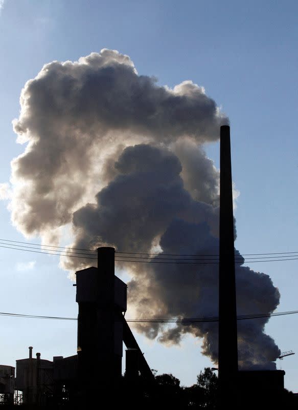 FILE PHOTO: Emissions are released from a factory chimney at an industrial park in Wollongong