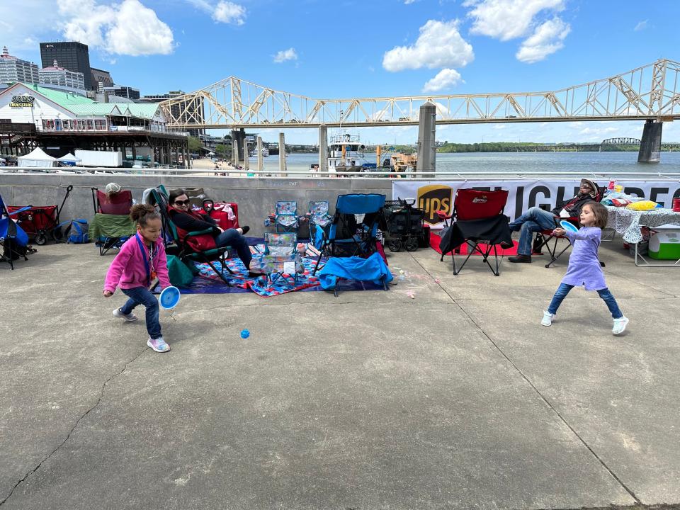 Two young girls, Desi and Sophia Ghiloni, hang out with their mom, Amanda, at the "UPS Flight Deck" and play catch ahead of Thunder Over Louisville. April 22, 2023