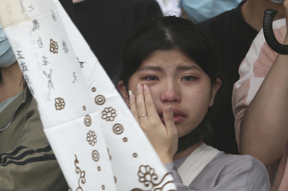 The families of the victims in a train crash cry as they mourn near Taroko Gorge in Hualien, Taiwan on Saturday, April 3, 2021. The train partially derailed in eastern Taiwan on Friday after colliding with an unmanned vehicle that had rolled down a hill, killing and injuring dozens. (AP Photo/Chiang Ying-ying)