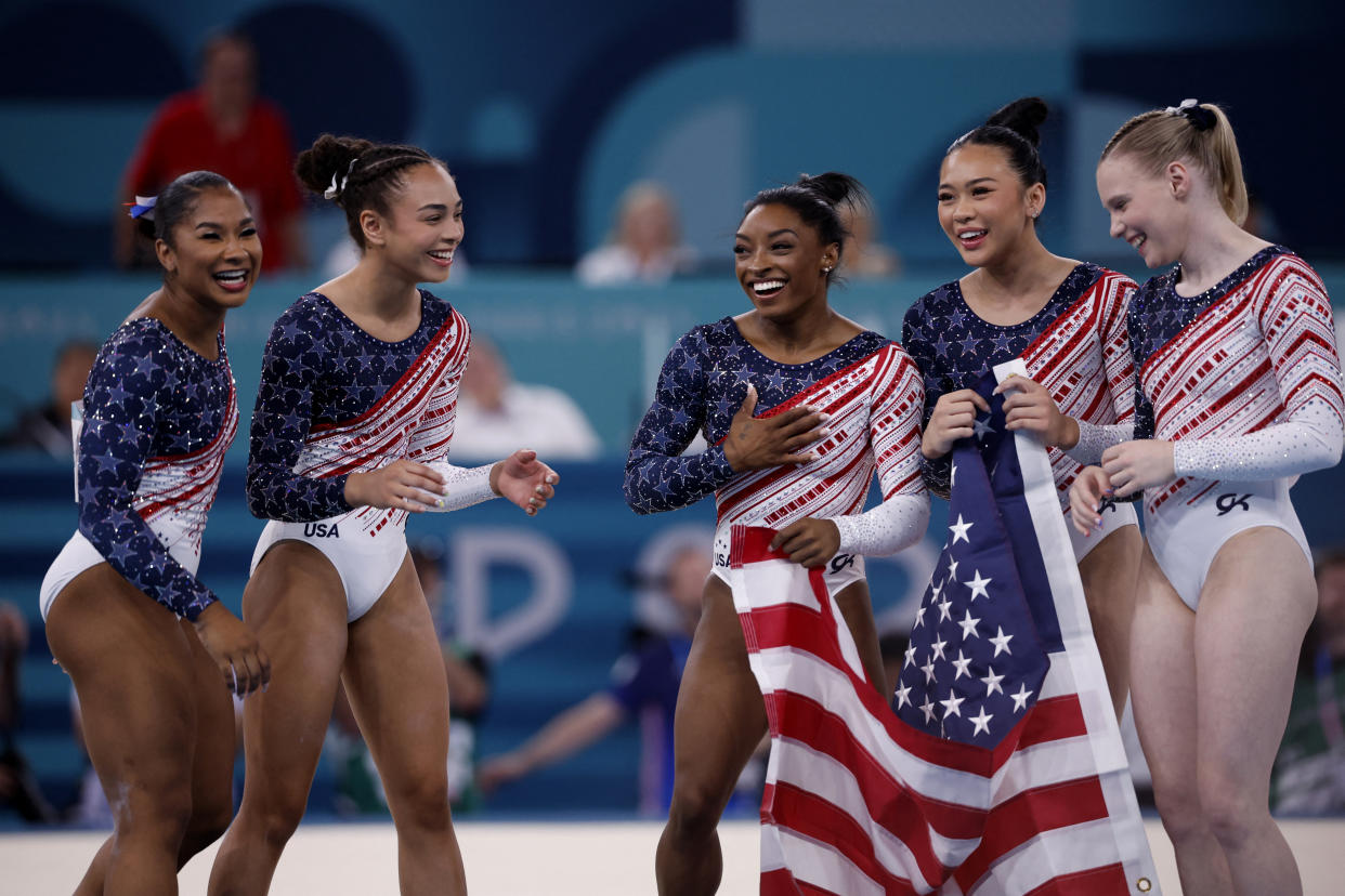 Simone Biles, Jordan Chiles, Jade Carey, Sunisa Lee and Hezly Rivera celebrate after winning gold at the 2024 Paris Olympics on Tuesday. (REUTERS/Amanda Perobelli)