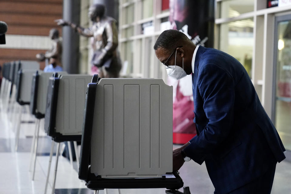 Philadelphia City Council President Darrell L. Clarke fills out his ballot at the opening of a satellite election office at Temple University's Liacouras Center, Tuesday, Sept. 29, 2020, in Philadelphia. Pennsylvania is one of this year's most hotly contested battleground states and also is facing a flurry of lawsuits, complaints and partisan finger-pointing over its election procedures and systems. (AP Photo/Matt Slocum)