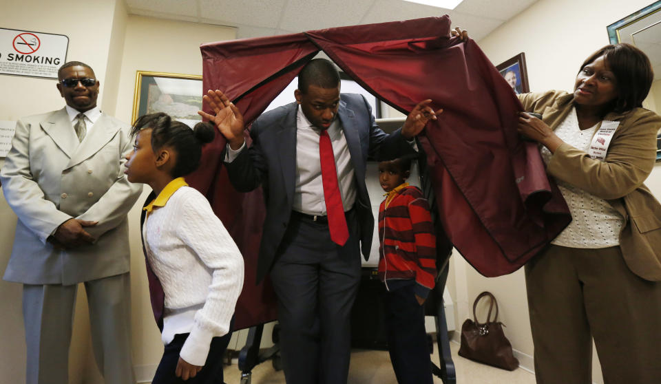 Newark mayoral candidate Shavar Jeffries, center, walks out of a voting booth with his children, Naomi Jeffries, 7, left, and Kaleb Jeffries, 9, after casting his vote, Tuesday, May 13, 2014, in Newark, N.J. The election will decide whether Jeffries, a former state assistant attorney general, or his opponent, City Councilman Ras Baraka, will take over the seat Cory Booker occupied from 2006 until October 2013, when he won a special election to succeed U.S. Sen. Frank Lautenberg, who died in office. (AP Photo)