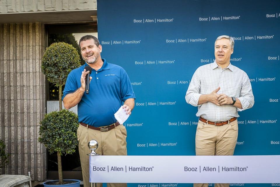 Booz Allen Hamilton Senior Vice President Mark Merz, left, and President and Chief Executive Officer Horacio Rozanski make comments to employees at the company's Agile Center of Excellence in Melbourne.