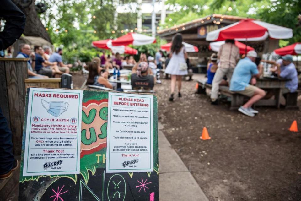 Signage about mask requirements are seen in Austin, Texas, restaurant.