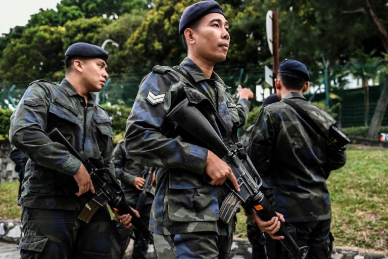 The two accused in the Kim assassination case arrived at a heavily guarded court for a hearing expected to see them enter a plea