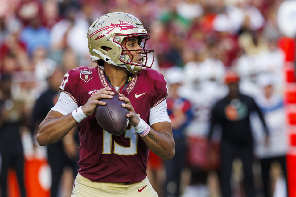 Florida State quarterback Jordan Travis looks for a receiver during the first half of an NCAA college football game against Miami, Saturday, Nov. 11, 2023, in Tallahassee, Fla. (AP Photo/Colin Hackley)