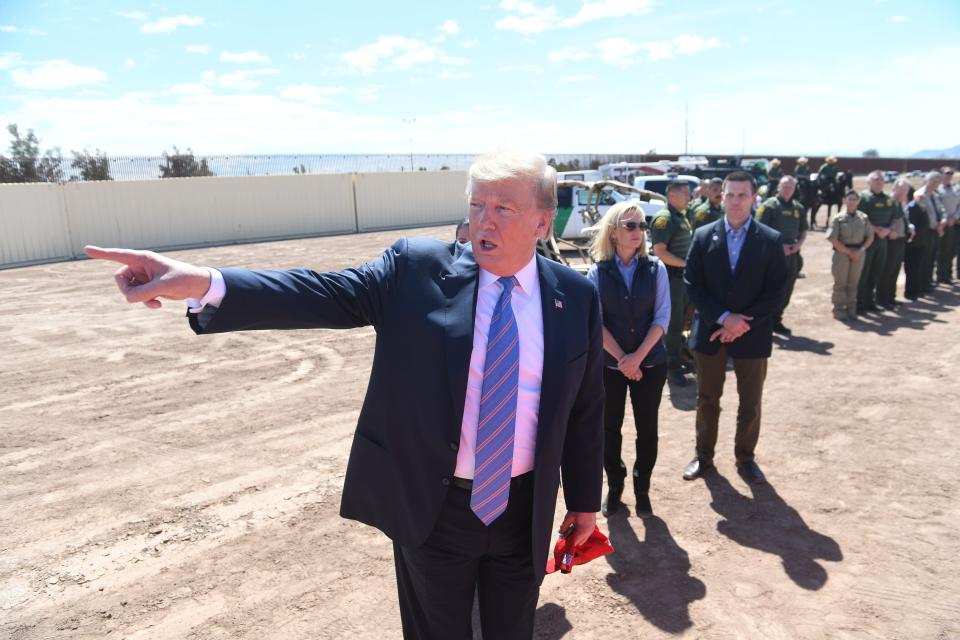 US President Donald Trump speaks with members of the US Customs and Border Patrol as he tours the border wall between the United States and Mexico in Calexico, California on April 5, 2019. - President Donald Trump landed in California to view newly built fencing on the Mexican border, even as he retreated from a threat to shut the frontier over what he says is an out-of-control influx of migrants and drugs. (Photo by SAUL LOEB / AFP)        (Photo credit should read SAUL LOEB/AFP/Getty Images)