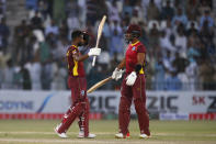 West Indies Shai Hope, left, celebrates with teammate Brandon King after scoring century during the first one day international cricket match between Pakistan and West Indies at the Multan Cricket Stadium, in Multan, Pakistan, Wednesday, June 8, 2022. (AP Photo/Anjum Naveed)