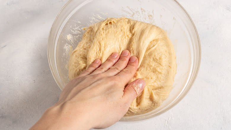 Kneading a dough inside a bowl