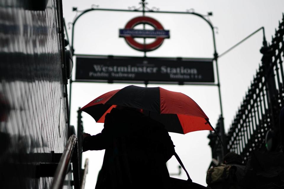 Commuters with umbrellas on a rainy morning in Westminster, London. (PA)