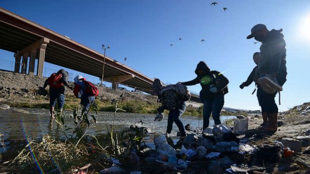 PHOTO: Migrants cross the US-Mexico border from Ciudad Juarez, Mexico, on Dec. 14, 2022. (Christian Chavez/AP)